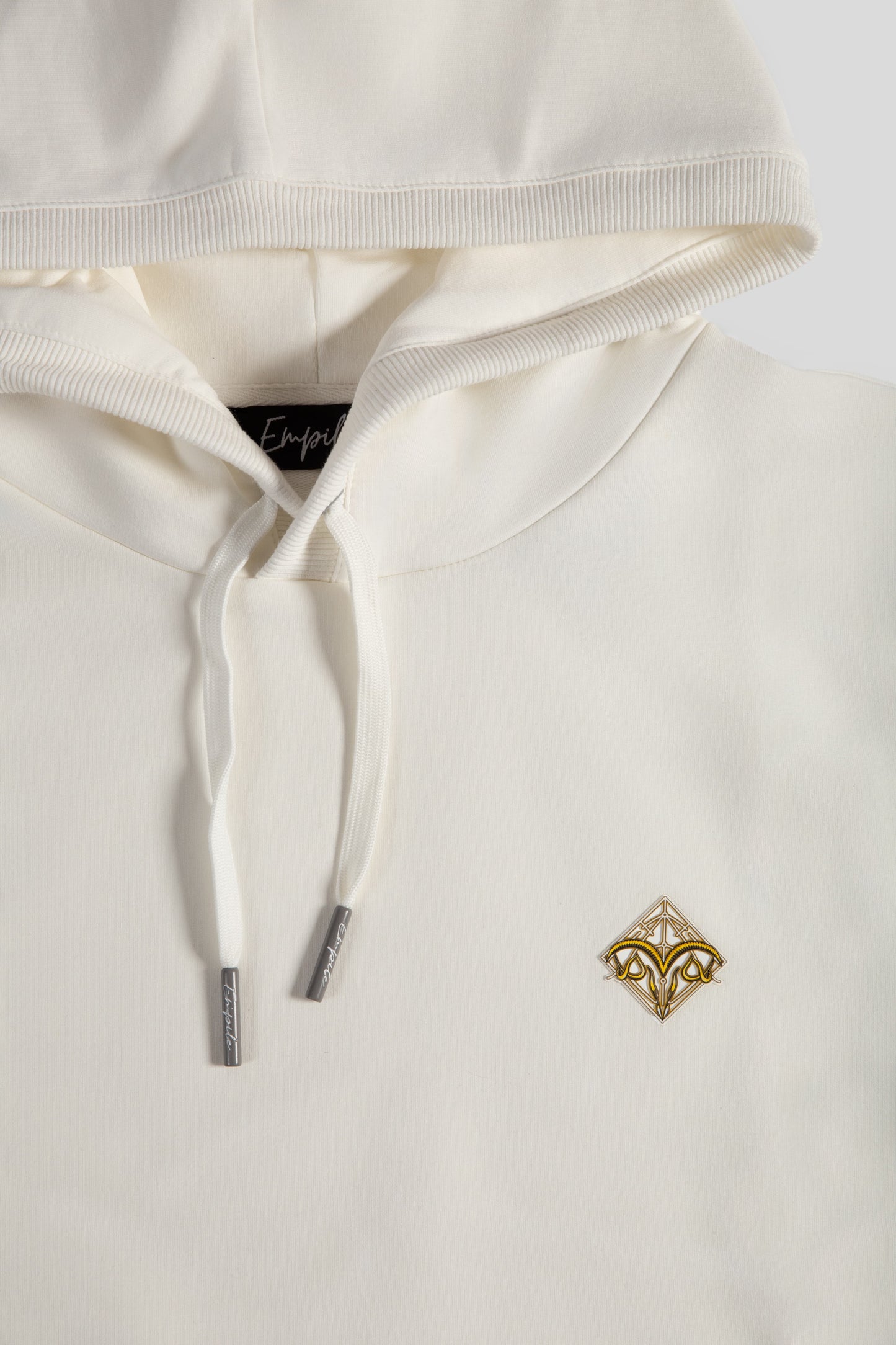Front details close up of the Empile white longline hoodie